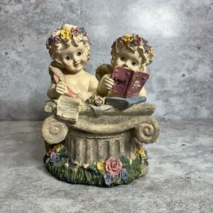 Charming Cherub Figurine with Floral Accents